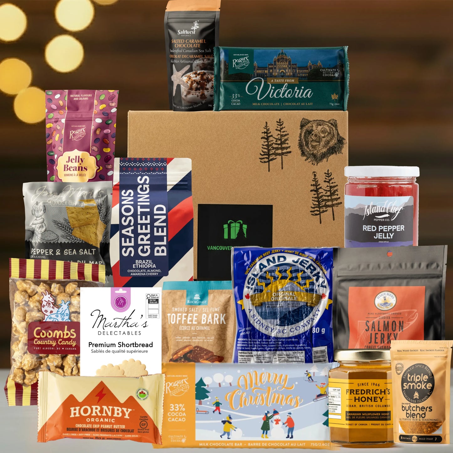 Assorted food products including snacks, candies, and jams on a wooden surface with a warm glow in the background.