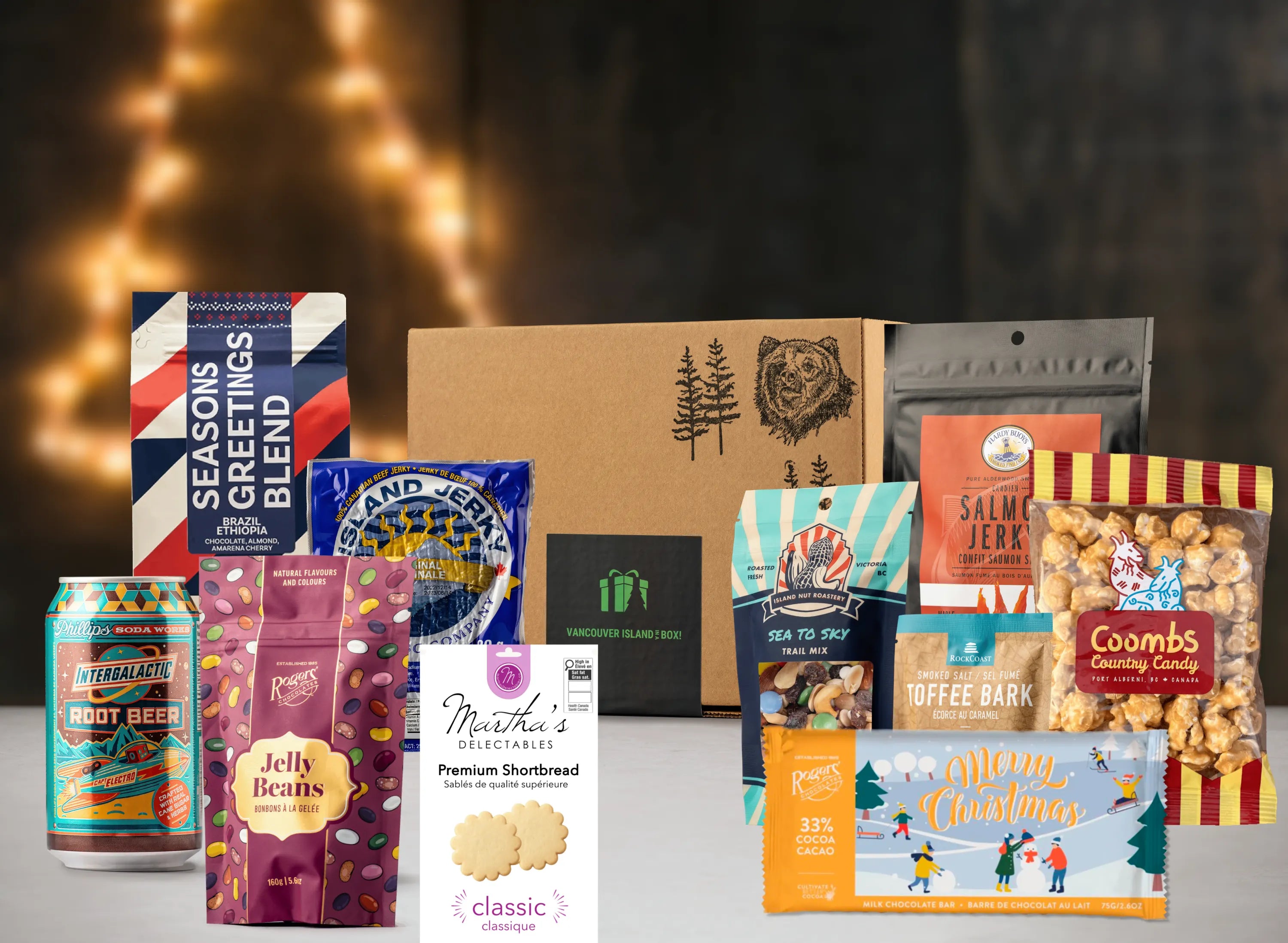 Assorted gift items including a box, snacks, and a can on a dark background with lights.