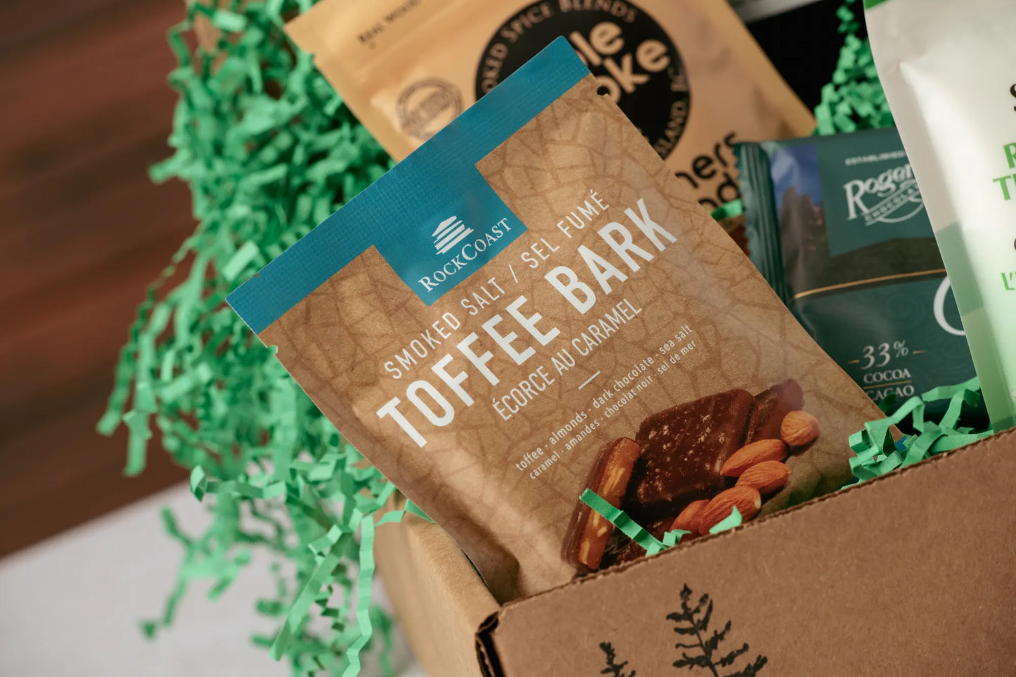 Box of toffee bark with green decorative elements